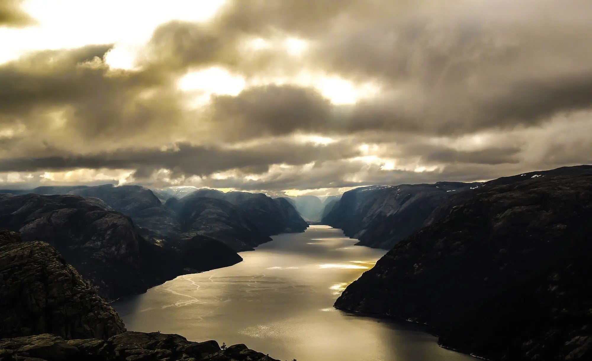 Billede 1 af Fototapet - Skyet fjordlandskab med sollys mellem fjelde