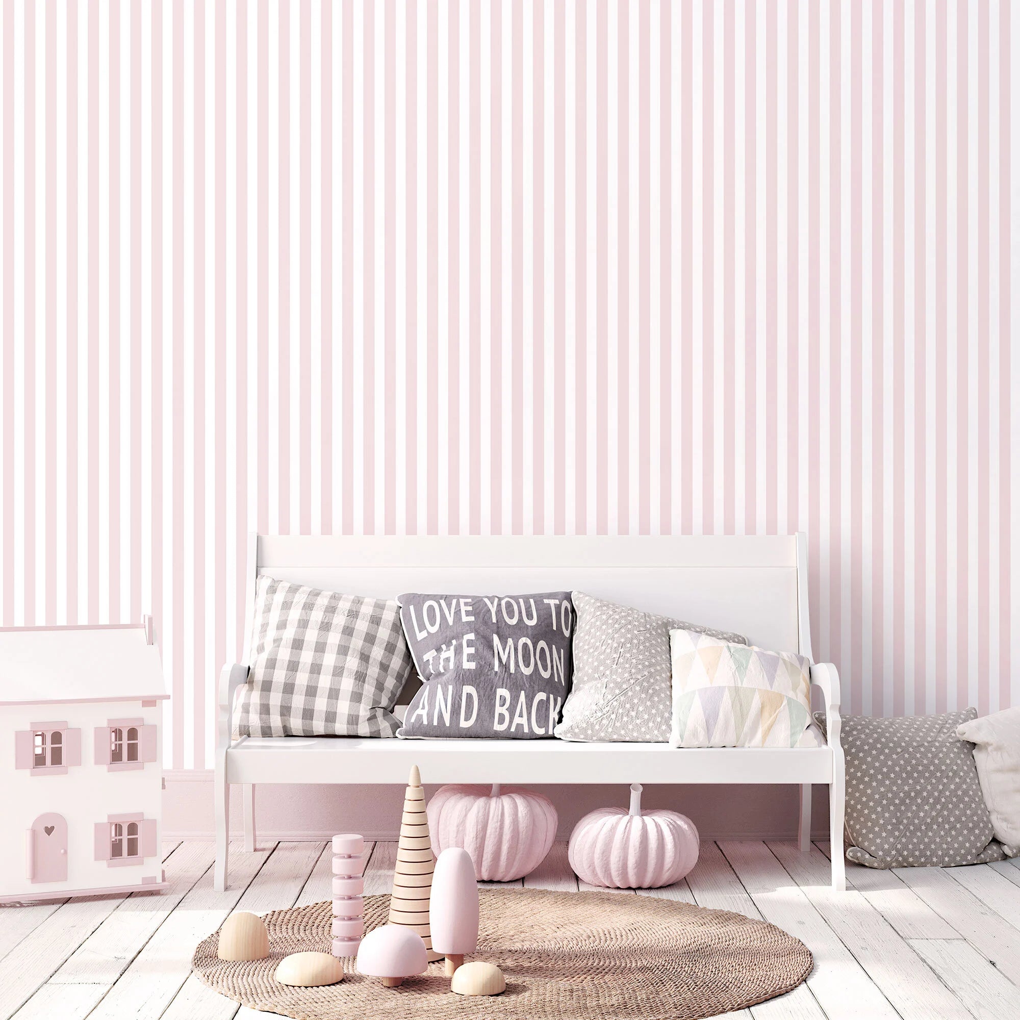 Interiørbillede der viser tapetet Stripe Stroll - Pastel Blush på en væg med en sofa og puder i forgrunden. Fra Nicetapet.dk.